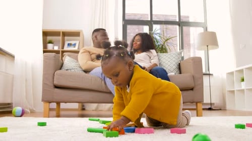 Cute Baby Girl Playing With Parents at Home