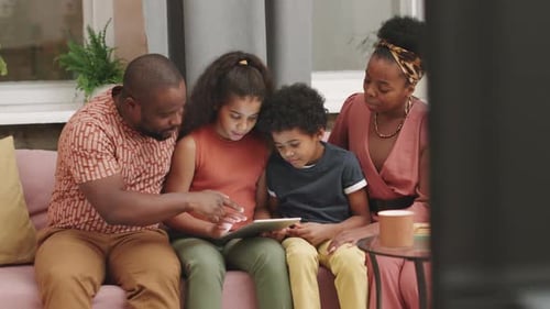 Family of Four Using a Tablet at Home