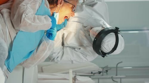 Dentist Performing Procedure on Patient in Hospital