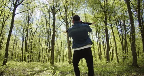 Dad and Daughter Playing in Sun Dappled Forest