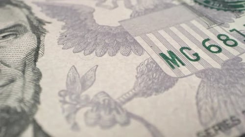 Panning across a 5 dollar bill