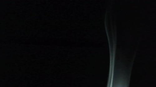 Wispy Smoke Flowing on Black Background