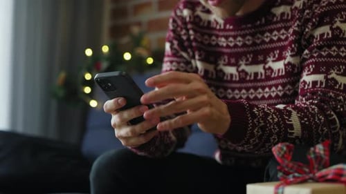 Man Using Mobile Phone at Christmas