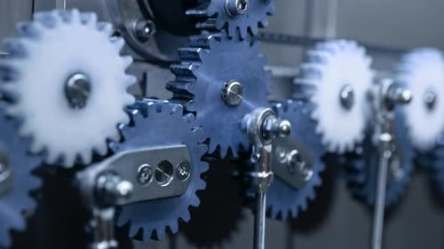Closeup of Steel Gears Spinning Inside Complex Engine Mechanism