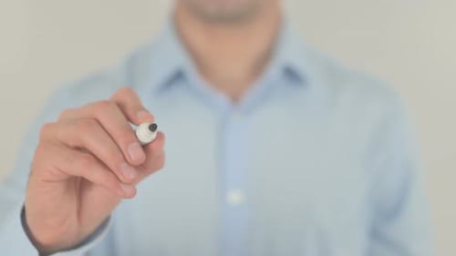 Man Writes 'Cookies' on Transparent Screen with Marker