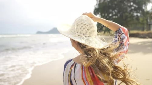 4K Portrait of Beautiful Caucasian woman walking on tropical beach in summer sunny day