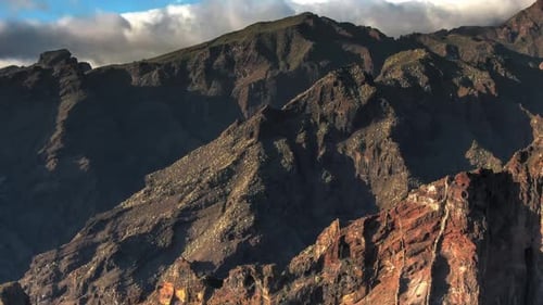 Rugged Mountains and Jagged Peaks under Cloudy Sky