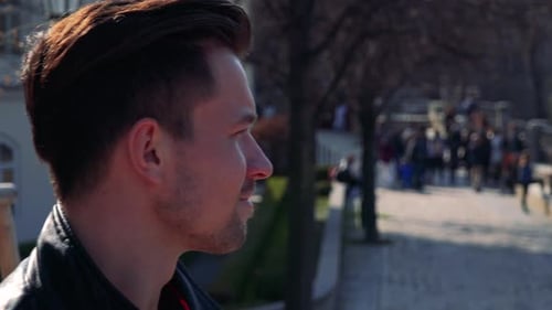 A Young Handsome Man Takes Photos with a Camera - Face Closeup - People on a Paved Path