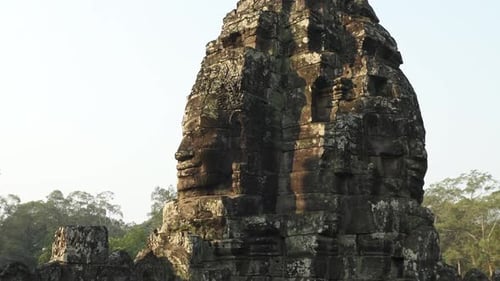 Back to Back Smiling Faces Carved on the Stone Ruins in Cambodia Temple