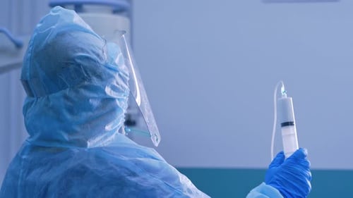 Medical Professional Prepares Injection in Hospital Setting