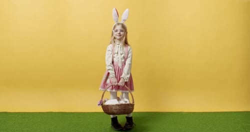 Adorable Girl Holding Easter Bunny Basket in Studio