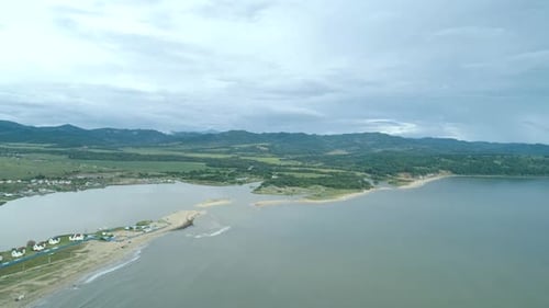 Aerial Shot Over the Sea in Summertime with Turquoise Water on Cloudy Day