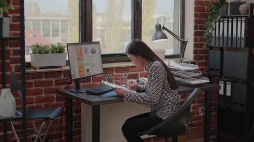 Young Woman Working at Her Computer in Office
