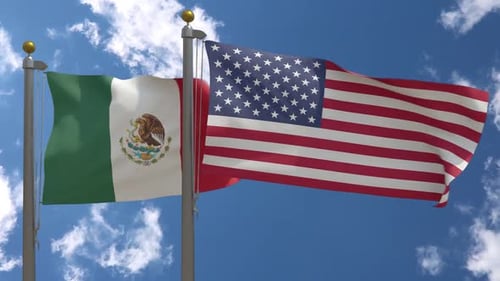 Flags of United States and Mexico Waving in Blue Sky