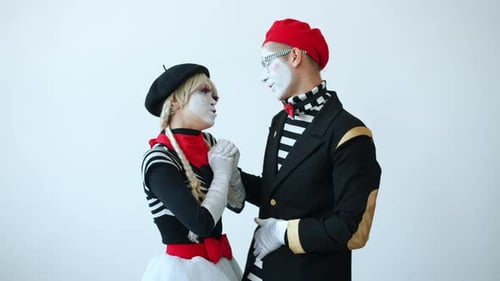 Two Mimes Interacting and Laughing Together