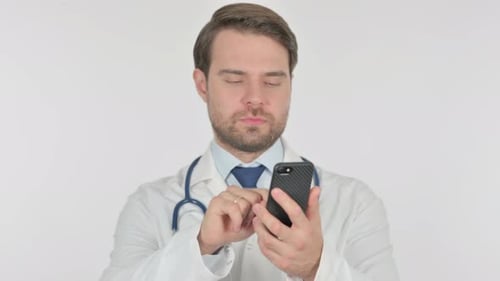 Doctor Using Smartphone for Communication in White Room