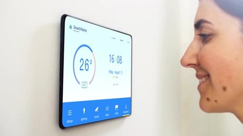 Woman Adjusts Smart Home Temperature with Touchscreen
