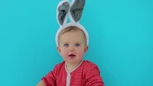 Cute Infant Wearing Novelty Bunny Ears Smiling
