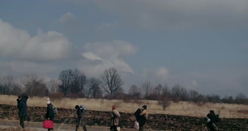 War Immigrants With Luggage Walking On Road
