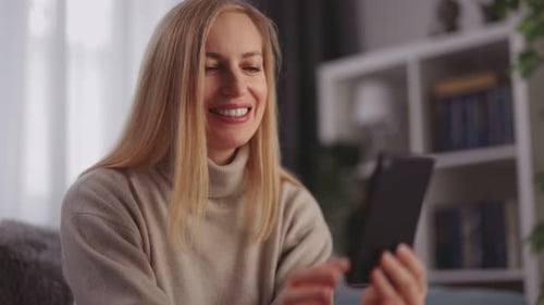 Woman Smiling and Video Calling on Smartphone