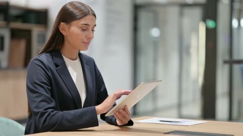 Woman Using Tablet in Modern Office Environment