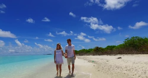 Young man and woman in love dating on vacation enjoy life on beach on clean white sand background 4K