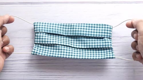 Top View of Man Hand Holding Homemade Face Mask,