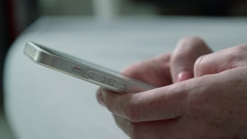 Hands Using Silver Smartphone Close Up