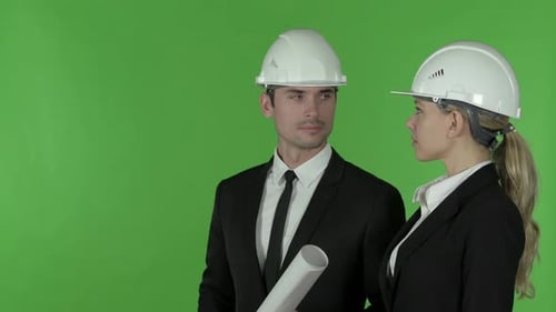 Female Engineer Pointing Up Standing with Male Engineer , Chroma Key