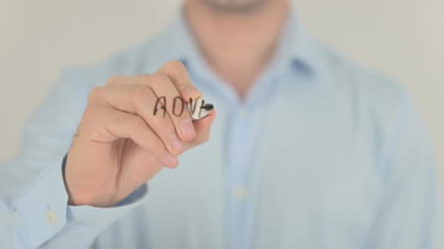 Hand Writes Advertising Campaign on Glass Surface