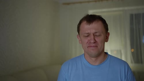 Distressed Man Refuses Tissue with Hand Gesture