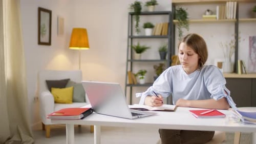 Teen Girl Studying at Home Using Laptop