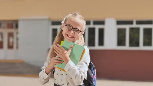 Portrait of Smiling School Girl Child with Backpack and Books