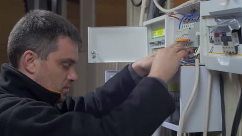 Electrician Fixing Electrical Wiring in Panel