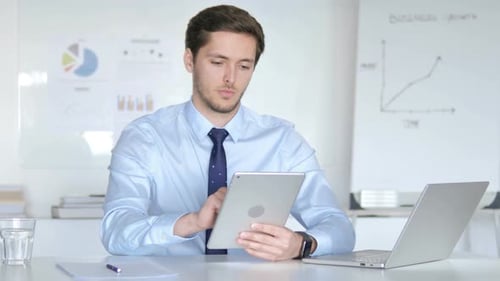 Young Businessman Using Tablet