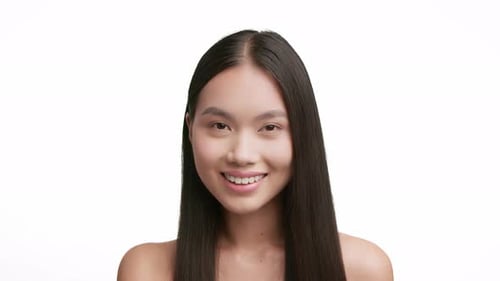 Smiling Woman Styling Long Black Hair