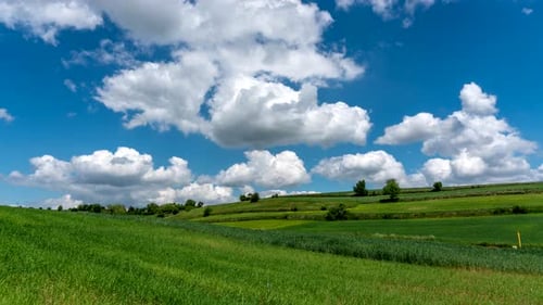 Clouds Drifting Over Rolling Hills Landscape