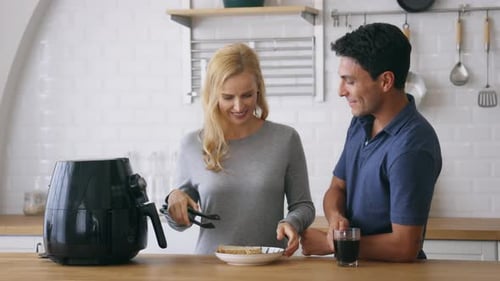 Couple Preparing Meal in Air Fryer
