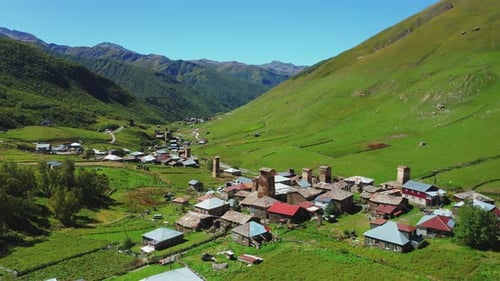 Aerial View of a Mountain Village Along the River in the Middle of a Sunny Day