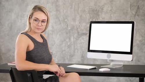 Woman At Desk With Computer and Blank Screen