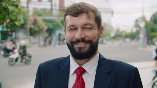 Smiling man in suit on city street