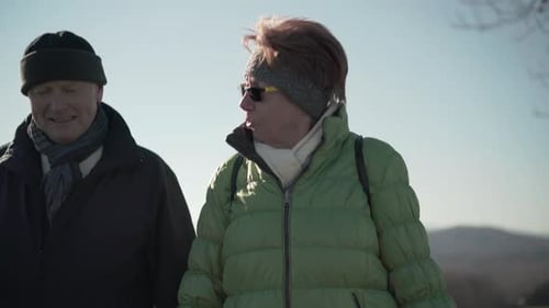 Adults Walking Together on Hill During the Day