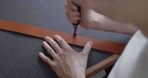 Using Electric Grooving Iron During Leather Belt Making Process