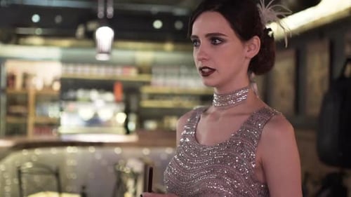 Closeup Portrait of a Young Attractive Woman in a 1920s Style at the Bar
