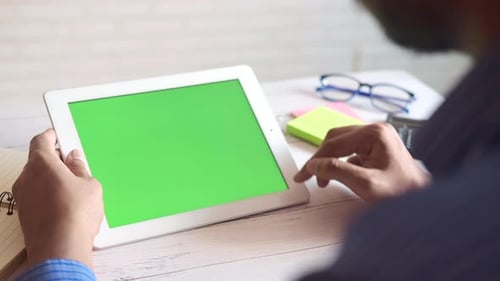 Businessman Using Digital Tablet on Office Desk