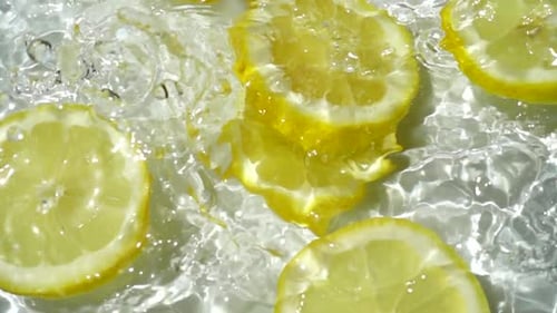Lemon Slices Splashing in Water, Close-Up