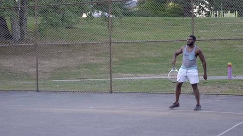 Athletic Guy Serving During A Tennis Match At The Tennis Court - full slowmo shot