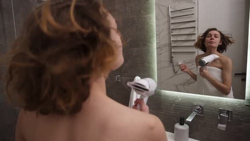 Woman Dries Hair in Bathroom and Talks to Reflection