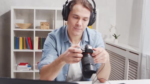 Workplace of freelance worker at home office. Young man works using computer.
