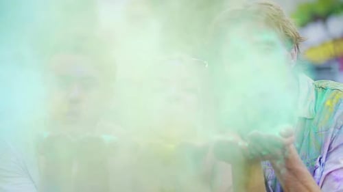 Friends Celebrate Holi, Blowing Color Powder